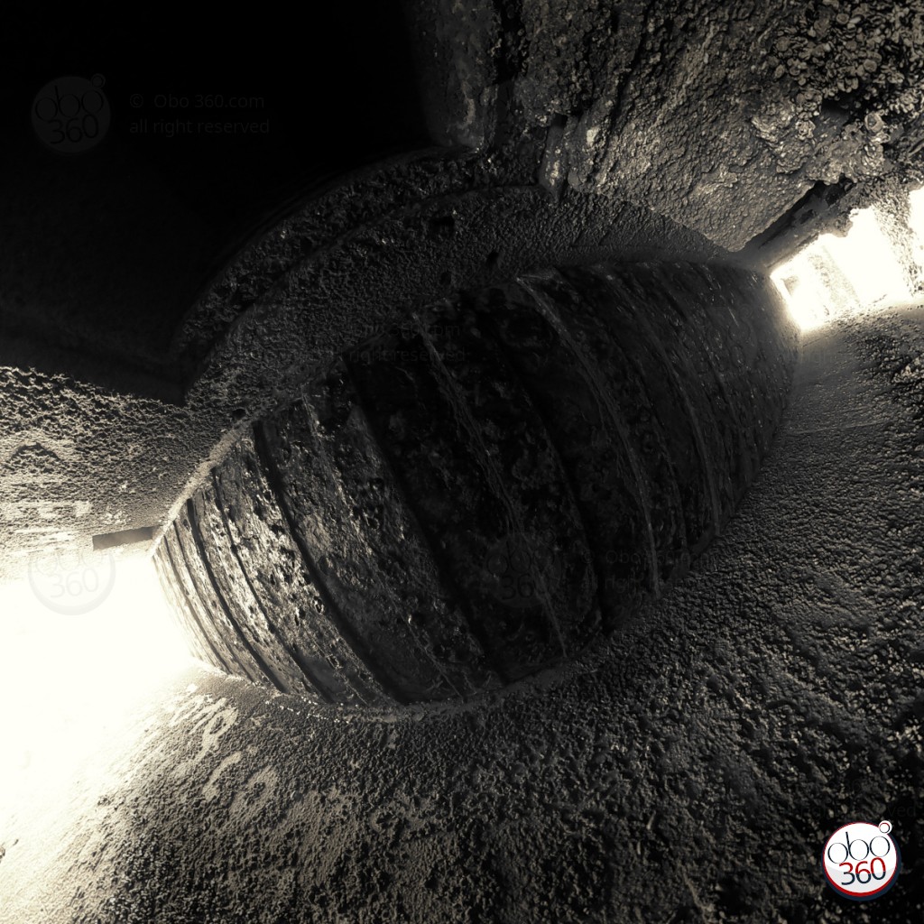 Black and white artistic composition made from a 360° shot.Photo captured in a semi-submerged corridor of a German bunker dating from second World War, on a beach somewhere in Brittany.